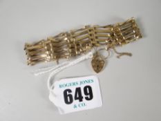 A 9ct yellow gold gate bracelet with tapered ends and attached heart-shaped pad-lock, 9gms Please