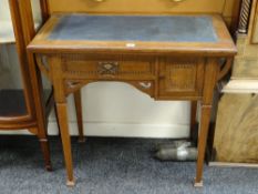 A vintage kneehole desk with marquetry detail and tooled leather top, 83cms wide