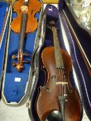 Two cased vintage violins