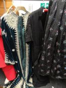 A VINTAGE BLACK LADIES DRESS decorated with sprigs of flowers and bearing a label for Marjon Couture