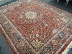 A GOOD KESHAN WOOL PILE floral rust ground and blue carpet, approximately 365cmsx277cms