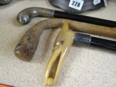 THREE WALKING STICKS one with white metal possibly silver mount, the other with a white metal,