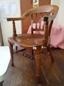 A DARK STAINED SMOKER'S CHAIR with turned legs and stretchers