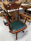 A BOUDOIR CHAIR in the Oriental-style in dark wood with gilt detail to spindle back and arms on a