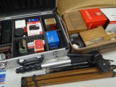 A RIGID METAL CAMERA CASE containing some camera equipment and lenses together with another