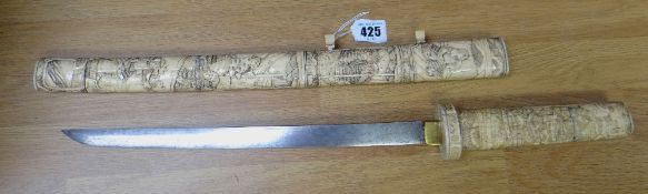 SWORD being a Japanese curved short sword or tanto, having sectional carved bone handle and sheath.