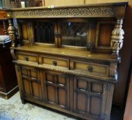 A REPRODUCTION JACOBEAN STYLE COURT CUPBOARD with leaded-glazed two door top and three-drawer