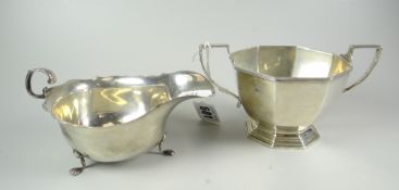 SILVER twin-handled octagonal sucrier together with silver sauce-boat raised on three paw type feet,