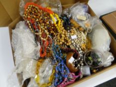 A CARDBOARD BOX CONTAINING A LARGE QUANTITY OF MIXED COSTUME JEWELLERY AND BEADS etc.
