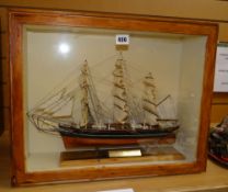 A CUTTY SARK MODEL the ship within a bespoke cabinet display, the ship raised on a plinth with