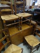 GOOD OAK DROP-LEAF DINING TABLE, together with a set of four matching ladderback and rush-seated