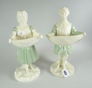 A PAIR OF ROYAL WORCESTER FIGURES in the form of a court entertainer lifting his cloak at the