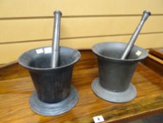 TWO SIMILAR CAST IRON CYLINDRICAL PESTLE AND MORTAR SETS (2)