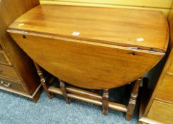 OAK DROP-LEAF GATE LEG TABLE having turned legs raised on scroll-type feet