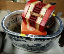 A BLUE & WHITE WILLOW PATTERNED DECORATED FOOT BATH together with a boxed concertina
