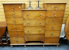 MAHOGANY CHEST OF DRAWERS arranged in three banks raised on turned feet, having brass drop