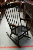 A DARK OAK SPINDLE BACK ROCKING CHAIR