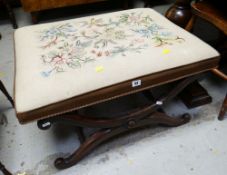 A LARGE UPHOLSTERED TOPPED CROSS-ENDED AND CARVED DECORATED STOOL