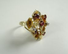 14 CARAT YELLOW GOLD RING set with small rubies and two tiny diamond chips in an abstract form 10