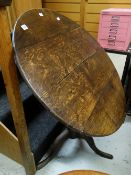 AN ANTIQUE OAK TILT TOP BREAKFAST TABLE