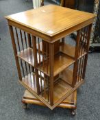 EARLY C20TH MAHOGANY SQUARE SECTION REVOLVING BOOKCASE raised on shaped legs and ceramic castors