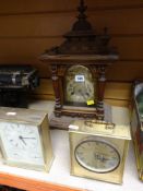 A BRASS FACED WOODEN CASED MANTEL CLOCK together with two others