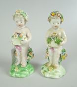 A PAIR OF DERBY PORCELAIN FIGURES modelled as putti with baskets of flowers, 10cms high