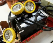 THREE MINERS/FIREMENS HELMET LAMPS, together with battery packs
