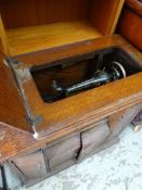 A VINTAGE SINGER TREADLE SEWING MACHINE in a wooden case together with various contents