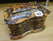 A REGENCY TORTOISESHELL SERPENTINE TEA CADDY on original four-corner bun feet, the hinging lid