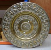 A LARGE CIRCULAR BRASS WALL CHARGER decorated with signs of the zodiac and Far Eastern symbols