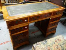 A REPRODUCTION YEW WOOD KNEEHOLE DESK with green leather tooled top