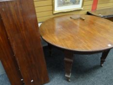 LATE C19TH-EARLY C20TH MAHOGANY EXTENDING DINING TABLE having two additional leaves raised on square