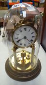 A GLASS DOMED SKELETON MANTEL CLOCK in brass effect