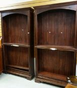 A PAIR OF DARK STAINED PINE TWO SECTION BOOKCASES.