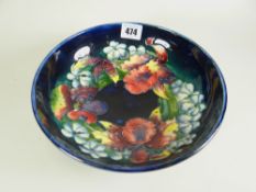 A MOORCROFT BLUE GROUND FOOTED CIRCULAR BOWL, the interior decorated with various tube lined