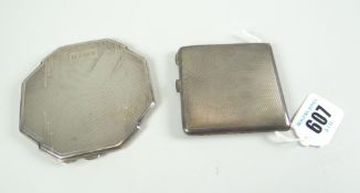 TWO SILVER COMPACTS one of engine turned Art Deco decoration and shape and with monogram, the