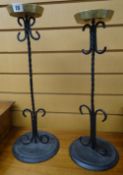 TWO SIMILAR CAST IRON SCROLL AND SPIRAL DESIGN CANDLESTICK HOLDERS