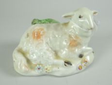 A DERBY PORCELAIN MODEL of a reclining sheep, 8cms long
