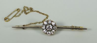 DIAMOND SEVEN STONE FLOWER HEAD OR CLUSTER BAR BROOCH set in yellow metal. Overall diamond carat