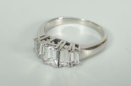 WHITE METAL EMERALD CUT FIVE STONE DIAMOND RING, set with five graduated diamonds. Total diamond