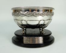 WHITE METAL CIRCULAR BOWL having four scroll feet raised on ebonized plinth, marked P Orr & Sons