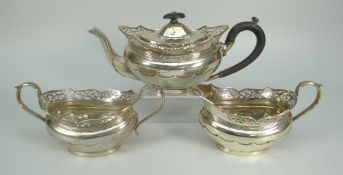GEORGE V THREE-PIECE SILVER TEASET comprising teapot, sucrier and cream jug, all with pierced scroll