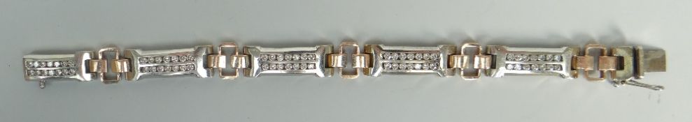 14K WHITE AND ROSE GOLD DIAMOND BRACELET set with 70 round cut brilliant diamonds, 21cms long, 51