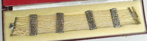 A BELLE EPOQUE DIAMOND AND SEED PEARL CHOKER NECKLACE of fourteen strands with four floral diamond