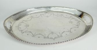 GEORGE V SILVER TWIN HANDLED TRAY OF OVAL FORM HAVING PIERCED BORDER with engraved swag and floral