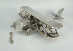 EARLY 20TH CENTURY WHITE METAL TWO SECTION MODEL OF A BI PLANE with engraved inscription to wings 