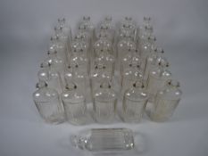 APOTHECARY BOTTLES - Thirty one clear glass ribbed bottles, 3.5 fl ozs (approximately 100 ml), 13.
