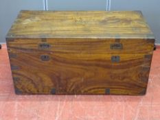 A VINTAGE CAMPHOR WOOD CHEST with brass banding and iron carry handles, 51 cms high, 103 cms wide,