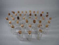 APOTHECARY BOTTLES - Forty clear glass tincture bottles marked 'Teaspoons' and with original paper